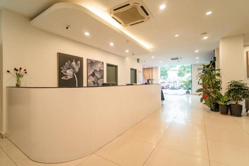 a lobby with a reception counter and potted plants at Tune Hotel KLIA Aeropolis (Airport Hotel) in Sepang