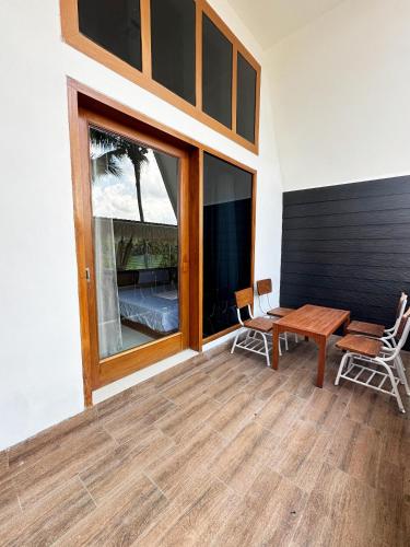 a room with a table and chairs and a window at Bukit Langit Campventure in Glagah