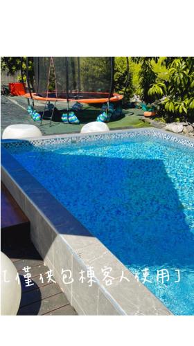 a large blue swimming pool with writing on it at 宜蘭冬山森活漫漫民宿 in Kung-pu-ch'eng