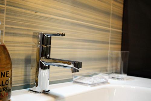 a bathroom sink with a chrome faucet next to a window at Affittacamere Piazza Castello in Manarola
