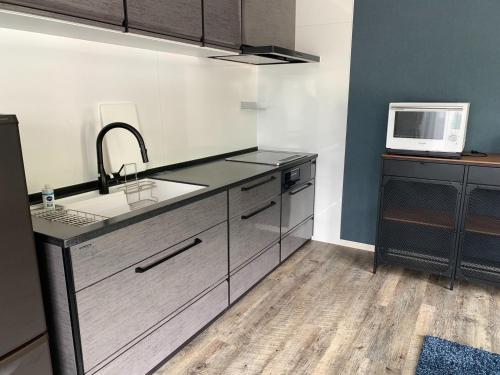 a kitchen with a sink and a microwave at Re,AERU - Vacation STAY 93903v in Minamiboso