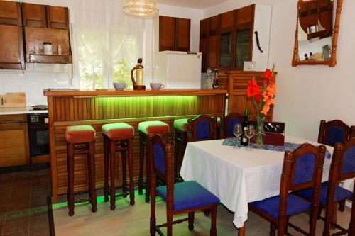 a kitchen with a table and some chairs and a counter at Apartments and Rooms Minex in Trebinje