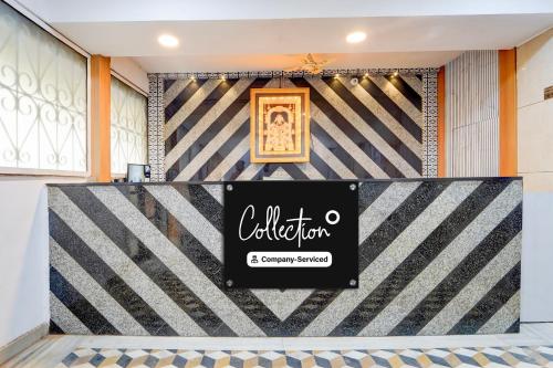 a sign for a store in front of a striped wall at Super Collection O Market Road Ernakulam in Cochin