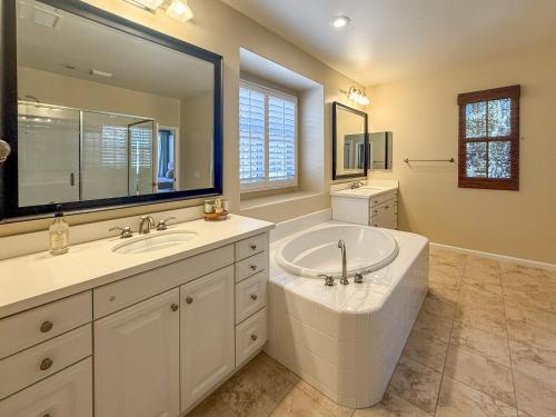 a bathroom with a tub and a sink and a mirror at #Marbella Lane - Vibrant 4BR Home in Irvine in Irvine