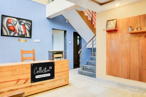 a lobby of a house with a staircase at Super Collection O Khatri Park Formerly Aum Villa in Lonavala