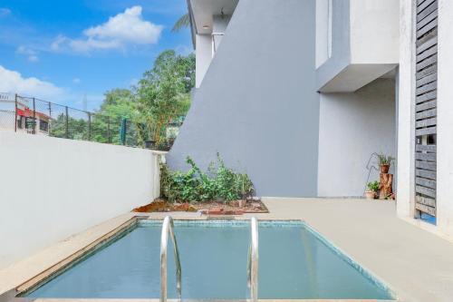 a swimming pool on the roof of a building at Super Collection O Khatri Park Formerly Aum Villa in Lonavala