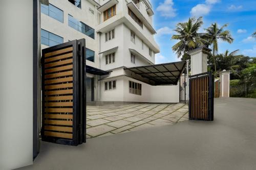 a building with a gate in front of it at Super Townhouse Thondayad Calicut Formerly Dream Casa in Kakkayam