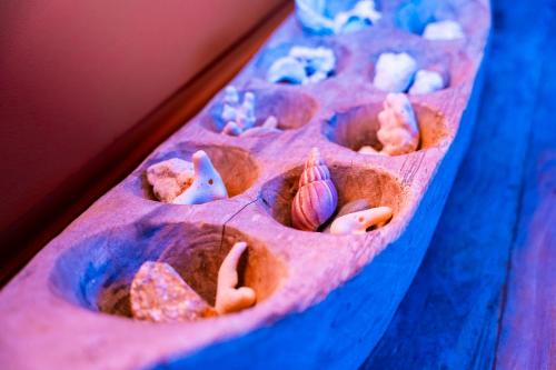 a row of donuts with seashells on a table at Villa Vanilla in Port Glaud