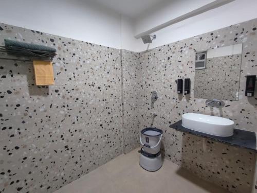 a bathroom with a sink and a mirror at Staeg Nirvana 2BHK in Indore