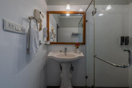 a bathroom with a sink and a mirror and a shower at Rajasthan Palace - A Heritage Boutique Hotel in Jaipur in Jaipur