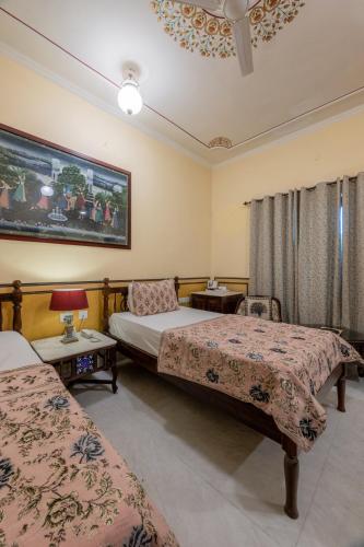 a hotel room with two beds and two tables at Rajasthan Palace - A Heritage Boutique Hotel in Jaipur in Jaipur