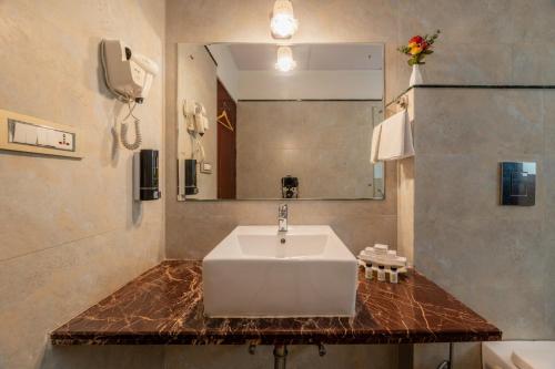 a bathroom with a sink and a mirror at Rajasthan Palace - A Heritage Boutique Hotel in Jaipur in Jaipur