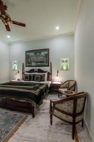 a bedroom with a bed and a ceiling fan at Rajasthan Palace - A Heritage Boutique Hotel in Jaipur in Jaipur