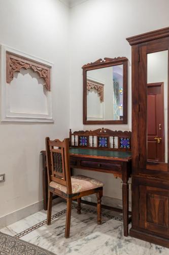 a dressing table with a mirror and a chair at Rajasthan Palace - A Heritage Boutique Hotel in Jaipur in Jaipur