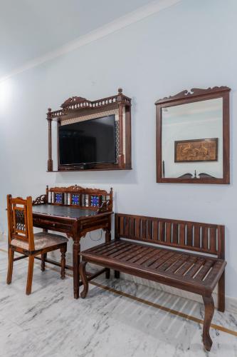 a room with two benches and a table and a mirror at Rajasthan Palace - A Heritage Boutique Hotel in Jaipur in Jaipur