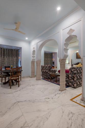 a living room with white walls and a marble floor at Rajasthan Palace - A Heritage Boutique Hotel in Jaipur in Jaipur