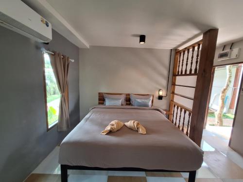 a bedroom with a bed with a towel on it at The Seasons At Pai in Pai