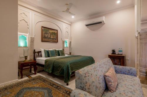 a bedroom with a bed and a couch at Rajasthan Palace - A Heritage Boutique Hotel in Jaipur in Jaipur