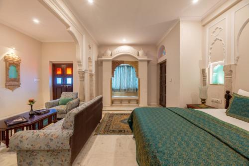 a large bedroom with a bed and a couch at Rajasthan Palace - A Heritage Boutique Hotel in Jaipur in Jaipur