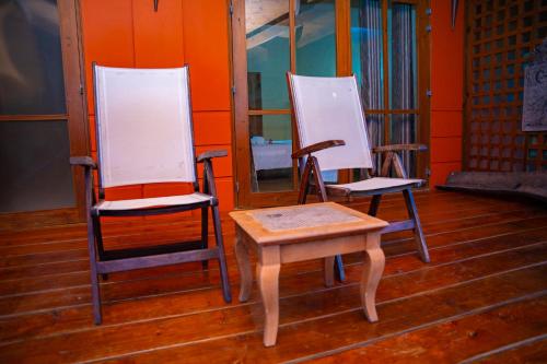 a pair of chairs and a table in a room at Villa Vanilla in Port Glaud