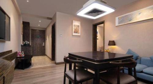 a living room with a table and a couch at Landmark Hotel in Zhuhai