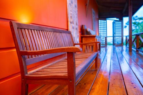two wooden benches sitting in a room at Villa Vanilla in Port Glaud