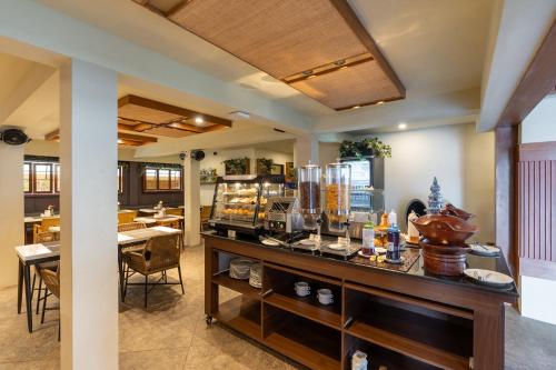 a restaurant with a counter with food on it at Villa Kayu Raja in Seminyak
