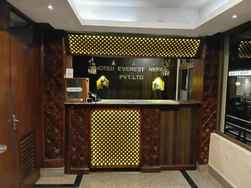 a bar in a restaurant with a sign on the wall at Hotel Everest Nepal in Kathmandu
