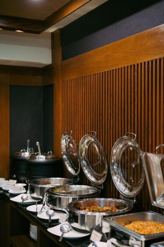 a row of trays of food in a restaurant at Villa Kayu Raja in Seminyak