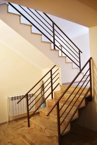 a staircase in a house with wooden steps and railing at Anna Home B&B in Areni