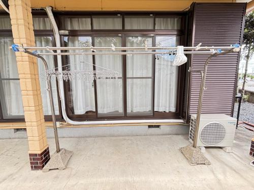 a shower in front of a house at 一棟貸しの宿 貸別荘 水戸ハウス Vacation Rental Mito House! Location is 1-2-55 Kanemachi Ibaraki Prefecture 場所は茨城県水戸市金町1-2-55です ドア横のキーボックスの番号はご予約後に,チェックイン情報を見る,をご覧下さい in Mito