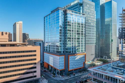 a tall glass building in a large city at Boulevard Stays Highrise STU Sky Pool Parking Gym 26 in Phoenix