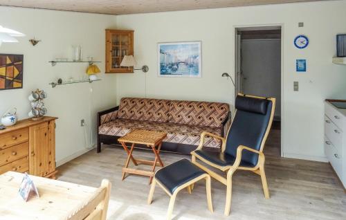 a living room with a couch and two chairs and a table at One-Bedroom Holiday Home In Vejers Strand in Vejers Strand