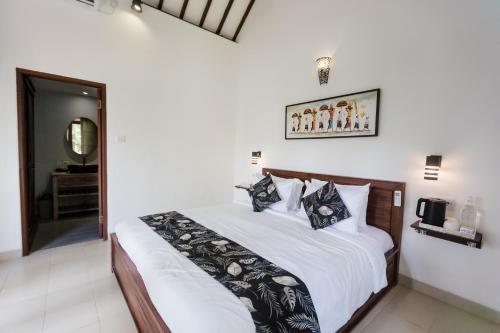 Postel nebo postele na pokoji v ubytování Sundhara View Ubud
