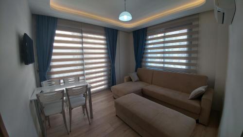 a living room with a couch and a table at Arti̇m Apart Hotel in Fethiye