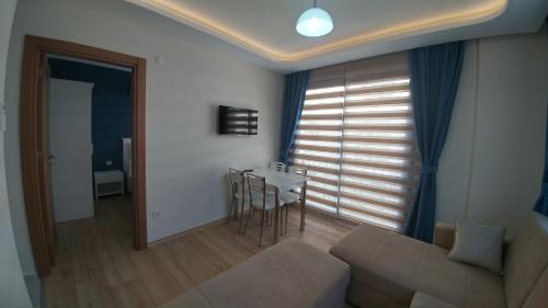 a living room with a couch and a table at Arti̇m Apart Hotel in Fethiye