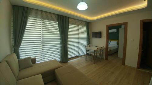 a living room with a couch and a table at Arti̇m Apart Hotel in Fethiye