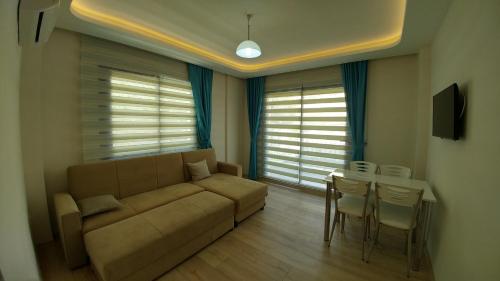 a living room with a couch and a table at Arti̇m Apart Hotel in Fethiye
