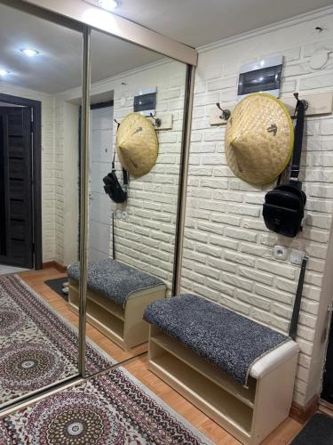 a sauna with mirrors and benches in a room at Квартира на огонбаева in Bishkek