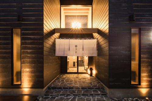 a hallway of a building with a window and a door at Beppu 乃音 in Beppu