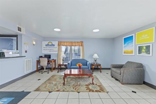 a living room with a couch and a table at Days Inn by Wyndham McKinney in McKinney