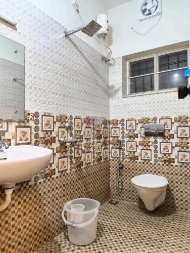 a bathroom with a sink and a toilet at Yatra Homestay in Trivandrum