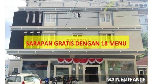 a store with a yellow sign on the side of a building at Hotel 95 in Pontianak