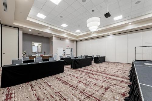 a large room with tables and chairs in it at Hilton Garden Inn Martinsburg in Martinsburg