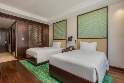 Ένα ή περισσότερα κρεβάτια σε δωμάτιο στο Hilton Da Nang
