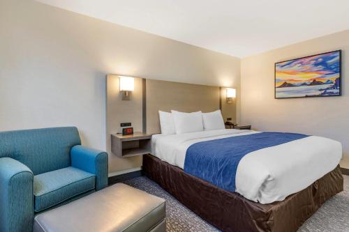 a hotel room with a bed and a chair at Comfort Inn San Diego Miramar in Miramar