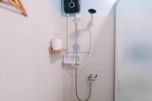 a shower with a shower head in a bathroom at Cove Hideaway at Mesavirre in Bacolod