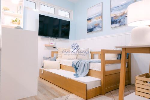 a room with a bunk bed and a tv at Cove Hideaway at Mesavirre in Bacolod