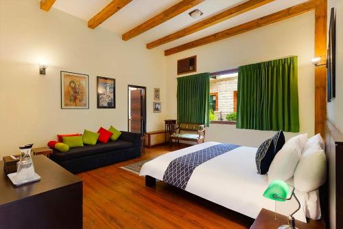 a bedroom with a large bed and a couch at Mistair Garden Luxurious Villa Kasauli in Kasauli