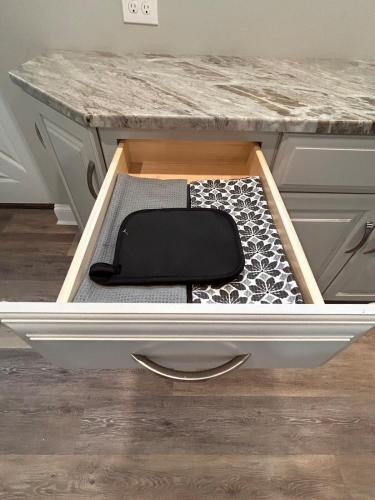 a drawer in a desk with a black and white rug at The Highland Oasis in Ephrata